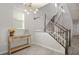 Bright foyer with hardwood floors, elegant chandelier, and a staircase leading to the upper level at 12064 Encore At Ovation Way, Winter Garden, FL 34787