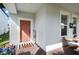 Welcoming front porch with a modern door, elegant decor, and charming curb appeal at 12064 Encore At Ovation Way, Winter Garden, FL 34787