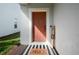 Stylish front door with brick flooring and a welcoming sign and rug at 12064 Encore At Ovation Way, Winter Garden, FL 34787