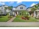 Charming two-story home with a landscaped yard, walkway, and a welcoming covered front porch at 12064 Encore At Ovation Way, Winter Garden, FL 34787