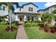 Charming two-story home with a landscaped yard, walkway, and a welcoming covered front porch at 12064 Encore At Ovation Way, Winter Garden, FL 34787