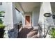 Inviting front porch with stone supports, brick flooring, and a stylish front door at 12064 Encore At Ovation Way, Winter Garden, FL 34787