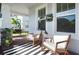 Inviting front porch with comfortable seating, stylish decor, and a relaxing atmosphere at 12064 Encore At Ovation Way, Winter Garden, FL 34787