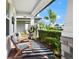 Cozy front porch featuring comfortable seating and views of the lush, landscaped front yard at 12064 Encore At Ovation Way, Winter Garden, FL 34787