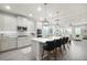 Modern kitchen featuring a large island with seating, stainless steel appliances, and open layout to the living area at 12064 Encore At Ovation Way, Winter Garden, FL 34787