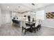 Open kitchen and dining area featuring a modern island with seating, stainless steel appliances and sleek lighting at 12064 Encore At Ovation Way, Winter Garden, FL 34787