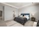 Elegant main bedroom with a blue bed frame and a view into ensuite bathroom at 12064 Encore At Ovation Way, Winter Garden, FL 34787