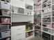 Organized walk-in pantry with custom shelving, drawers, and ample storage space for food and supplies at 12064 Encore At Ovation Way, Winter Garden, FL 34787