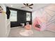 Playful room with a chalkboard wall, pink play tent and whimsical decor at 12064 Encore At Ovation Way, Winter Garden, FL 34787