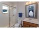 Bathroom featuring a glass-enclosed shower, updated vanity, and a bright, window-lit space at 15672 Shorebird Ln, Winter Garden, FL 34787