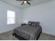 Neutral bedroom with a geometric-patterned bed set, side table, and ample natural light at 15672 Shorebird Ln, Winter Garden, FL 34787