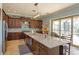 Kitchen island with granite counters, dark cabinets and pendant lighting at 15672 Shorebird Ln, Winter Garden, FL 34787