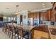 Modern kitchen features a granite island, stainless steel appliances and a breakfast bar at 15672 Shorebird Ln, Winter Garden, FL 34787