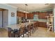 Kitchen with stainless steel appliances, dark cabinets, and granite countertop island with seating at 15672 Shorebird Ln, Winter Garden, FL 34787