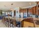 Modern kitchen features a granite island, stainless steel appliances and a breakfast bar at 15672 Shorebird Ln, Winter Garden, FL 34787