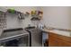 Functional laundry room with stainless steel washer and dryer, granite countertop, and ample storage at 15672 Shorebird Ln, Winter Garden, FL 34787