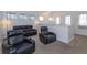 Upstairs living room with black sofas, lamps, and plenty of natural light at 15672 Shorebird Ln, Winter Garden, FL 34787
