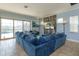 Open concept living room with a large sectional sofa and a view of the pool area at 15672 Shorebird Ln, Winter Garden, FL 34787