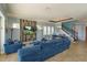 Bright living room with a blue sofa and a large wall-mounted television at 15672 Shorebird Ln, Winter Garden, FL 34787