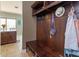 Mud room with a dark wood bench, storage and wall hooks at 15672 Shorebird Ln, Winter Garden, FL 34787