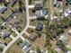 Wide aerial shot showing the layout of a residential neighborhood with houses, pools and roads at 1597 Lansfield Ave, Deltona, FL 32738