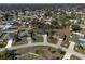 Aerial view of a home nestled in a well-established neighborhood, featuring tree-lined streets at 1597 Lansfield Ave, Deltona, FL 32738