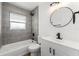 Modern bathroom featuring updated vanity, lighting and shower-bath combo at 1597 Lansfield Ave, Deltona, FL 32738