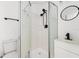 Updated bathroom featuring a shower stall, modern vanity, and round mirror at 1597 Lansfield Ave, Deltona, FL 32738