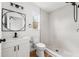 Updated bathroom featuring a walk-in shower, modern vanity, and round mirror at 1597 Lansfield Ave, Deltona, FL 32738