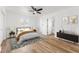 This spacious bedroom features a ceiling fan, neutral paint, wood flooring, and ensuite bathroom at 1597 Lansfield Ave, Deltona, FL 32738