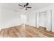 Bright bedroom with wood floors, white walls, ceiling fan, and closet at 1597 Lansfield Ave, Deltona, FL 32738