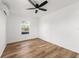 Bright bedroom with vinyl flooring, a window offering natural light and a ceiling fan with lights at 1597 Lansfield Ave, Deltona, FL 32738