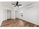 This bright bedroom features wood-look flooring, a ceiling fan and a window to the exterior at 1597 Lansfield Ave, Deltona, FL 32738