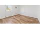 This bright bedroom features wood-look flooring, a window and a door to the exterior at 1597 Lansfield Ave, Deltona, FL 32738