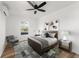 Primary bedroom with ceiling fan, neutral paint, wood flooring, decor, and natural light at 1597 Lansfield Ave, Deltona, FL 32738
