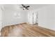 Large bedroom with wood-look floors and access to en suite bathroom at 1597 Lansfield Ave, Deltona, FL 32738