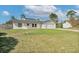 Charming single-story home with an attached garage and well-maintained lawn in a suburban neighborhood at 1597 Lansfield Ave, Deltona, FL 32738