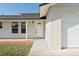 Inviting home entrance with a white front door and a well-lit porch at 1597 Lansfield Ave, Deltona, FL 32738