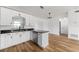 Modern kitchen featuring an island, stainless steel dishwasher, and granite countertops at 1597 Lansfield Ave, Deltona, FL 32738