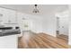 Open concept kitchen with wood floors and modern lighting at 1597 Lansfield Ave, Deltona, FL 32738
