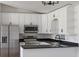 Bright kitchen featuring modern appliances, white cabinets, and granite countertops at 1597 Lansfield Ave, Deltona, FL 32738