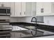 Kitchen with granite countertops, stainless steel appliances, and updated fixtures at 1597 Lansfield Ave, Deltona, FL 32738