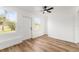 Light-filled room featuring wood-look flooring and large windows at 1597 Lansfield Ave, Deltona, FL 32738