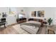Cozy bedroom/living room with wood floors, sofa bed, television, desk and chair at 1597 Lansfield Ave, Deltona, FL 32738