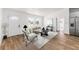 Bright living room features wood flooring, a modern ceiling fan, neutral paint, and a large window at 1597 Lansfield Ave, Deltona, FL 32738