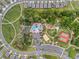Aerial view of community pool, tennis courts, playground and walking paths surrounded by neighborhood at 1598 Barberry Dr, Kissimmee, FL 34744