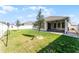 Well-maintained backyard with healthy grass, young trees, white fence, and screened-in patio at 1598 Barberry Dr, Kissimmee, FL 34744