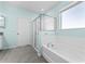 Bright bathroom featuring granite countertop, shower, and soaking tub at 1598 Barberry Dr, Kissimmee, FL 34744