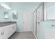 Bathroom with granite countertop, vanity and glass enclosed shower with blue walls at 1598 Barberry Dr, Kissimmee, FL 34744