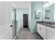 Bright bathroom with granite countertop, double sink, and glass-enclosed shower at 1598 Barberry Dr, Kissimmee, FL 34744